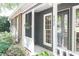 Inviting front porch with brick accents and well-maintained landscaping at 402 Roswell Green Ln, Roswell, GA 30075