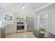 Bright kitchen featuring stainless steel appliances, a washer and dryer, and lots of storage at 402 Roswell Green Ln, Roswell, GA 30075