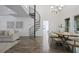 Bright living room features a spiral staircase, hardwood floors, and modern furnishings at 402 Roswell Green Ln, Roswell, GA 30075