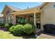 Backyard view of covered patio with hanging plants and lush landscaping at 530 Mount Park Dr, Powder Springs, GA 30127