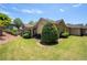 Scenic view of a well-maintained lawn and the rear facade of the house, including a covered patio at 530 Mount Park Dr, Powder Springs, GA 30127