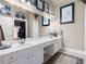 Bathroom boasts a double sink vanity and large framed mirror at 530 Mount Park Dr, Powder Springs, GA 30127