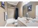 Neutral bathroom featuring tiled shower, tub, white vanity, and modern fixtures at 530 Mount Park Dr, Powder Springs, GA 30127
