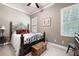 Comfortable bedroom with neutral walls, carpeted floors and a decorative, wrought iron bed frame at 530 Mount Park Dr, Powder Springs, GA 30127