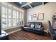 Bonus room boasts a dark-stained wood floor and cozy black reclining sofa at 530 Mount Park Dr, Powder Springs, GA 30127