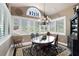 Dining room with a glass top table, multiple windows, and decorative chandelier at 530 Mount Park Dr, Powder Springs, GA 30127