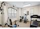 Dedicated exercise room with large windows, modern equipment, carpet and neutral walls at 530 Mount Park Dr, Powder Springs, GA 30127