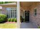 Inviting entryway with brick facade, decorative shutters, and manicured landscaping at 530 Mount Park Dr, Powder Springs, GA 30127
