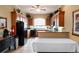 Traditional-style kitchen with wooden cabinets, black appliances, tiled floors, and ample counter space at 530 Mount Park Dr, Powder Springs, GA 30127