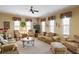 Bright living room featuring neutral walls, multiple windows, two sofas and two upholstered accent chairs at 530 Mount Park Dr, Powder Springs, GA 30127