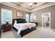 Main bedroom with trey ceilings, neutral walls, and ensuite bath access at 530 Mount Park Dr, Powder Springs, GA 30127