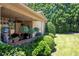 Covered patio with hanging plants and lush backyard landscaping at 530 Mount Park Dr, Powder Springs, GA 30127