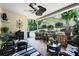 Cozy covered patio with ceiling fan, wicker furniture, and beautiful outdoor landscaping at 530 Mount Park Dr, Powder Springs, GA 30127