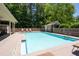 Outdoor pool area with a shallow end and lounge seating perfect for summertime relaxation at 530 Mount Park Dr, Powder Springs, GA 30127