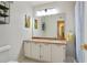 Bathroom with a single-sink vanity, large mirror, and light fixture; with a tiled floor at 1412 Oakridge Cir, Decatur, GA 30033
