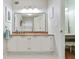 Bathroom featuring a white vanity with granite countertop, framed mirror, and white tile floor at 1412 Oakridge Cir, Decatur, GA 30033