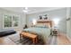 Spacious bedroom with a ceiling fan, hardwood floors, and a large window overlooking the yard at 1412 Oakridge Cir, Decatur, GA 30033
