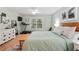 Bright bedroom featuring hardwood floors, ceiling fan, light-green walls, and a large window at 1412 Oakridge Cir, Decatur, GA 30033