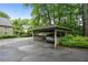 Covered carport providing parking, with mature trees and greenery visible around the structure at 1412 Oakridge Cir, Decatur, GA 30033