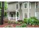 Well-maintained two-story home with a cozy front porch, landscaped yard, and an inviting entrance at 1412 Oakridge Cir, Decatur, GA 30033