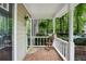 Charming covered front porch with brick flooring and a view of the landscaped front yard at 1412 Oakridge Cir, Decatur, GA 30033