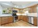 Well-equipped kitchen with wooden cabinets, stainless steel appliances, and hardwood floors at 1412 Oakridge Cir, Decatur, GA 30033