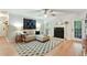 Cozy living room with hardwood floors, modern ceiling fan, and a fireplace at 1412 Oakridge Cir, Decatur, GA 30033