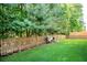 A lush, fenced backyard with a privacy fence provides space for relaxing and entertaining at 6418 Crown Forest Ct, Mableton, GA 30126