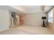 Spacious finished basement with carpet flooring, a TV and stairs at 6418 Crown Forest Ct, Mableton, GA 30126