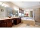 Bathroom featuring double sink vanity, soaking tub and glass enclosed shower at 6418 Crown Forest Ct, Mableton, GA 30126