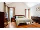 Comfortable bedroom featuring hardwood floors, vaulted ceiling, and matching dark wood furniture set at 6418 Crown Forest Ct, Mableton, GA 30126