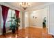 Dining area with hardwood floors, chandelier, and decorative wainscoting at 6418 Crown Forest Ct, Mableton, GA 30126