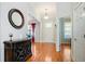 Welcoming foyer with hardwood floors, a stylish round mirror, and an entry to the dining area at 6418 Crown Forest Ct, Mableton, GA 30126