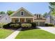 Charming home with inviting front porch, lush landscaping, and attached two-car garage at 6418 Crown Forest Ct, Mableton, GA 30126