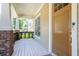 Charming front porch with brick accents and a view of the lush front yard at 6418 Crown Forest Ct, Mableton, GA 30126