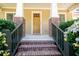 Inviting front porch with brick pillars, wood railings, and a charming wood front door at 6418 Crown Forest Ct, Mableton, GA 30126