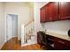 Dedicated home office space with built-in desk, hardwood floors, and staircase access at 6418 Crown Forest Ct, Mableton, GA 30126