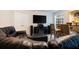 Spacious living room with leather seating, a large TV, and a bar area with seating at 6418 Crown Forest Ct, Mableton, GA 30126