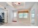 Open room with neutral walls, a ceiling fan, a window, and a door leading to the backyard at 6418 Crown Forest Ct, Mableton, GA 30126