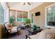 Bright sunroom with comfortable seating, plantation blinds, and lush plants at 6418 Crown Forest Ct, Mableton, GA 30126
