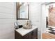 Stylish bathroom features a vessel sink, shiplap walls, wood-look tile flooring, and a view to the bedroom at 87 Peachtree Sw St # 209, Atlanta, GA 30303