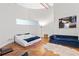 Spacious bedroom featuring a unique curved wall, wood flooring, and a comfortable sitting area at 87 Peachtree Sw St # 209, Atlanta, GA 30303