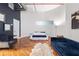 Spacious bedroom with a unique curved wall, wood flooring, and modern decor at 87 Peachtree Sw St # 209, Atlanta, GA 30303
