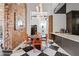 Eclectic dining room featuring modern lighting, exposed brick walls, and adjacent breakfast bar at 87 Peachtree Sw St # 209, Atlanta, GA 30303