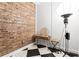Dressing area featuring vintage furniture, exposed brick, and checkerboard flooring at 87 Peachtree Sw St # 209, Atlanta, GA 30303