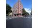 Exterior view of a brick building on a city street with crosswalks and traffic lights at 87 Peachtree Sw St # 209, Atlanta, GA 30303