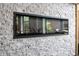 Sleek, modern fireplace integrated into a stylish stacked stone accent wall for a luxurious ambiance at 87 Peachtree Sw St # 209, Atlanta, GA 30303