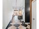 Long hallway with black and white checkered floors and access to the kitchen and living spaces at 87 Peachtree Sw St # 209, Atlanta, GA 30303