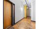 Hallway featuring wood floors, exposed pipes, and a stylish apartment entrance at 87 Peachtree Sw St # 209, Atlanta, GA 30303