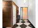 Hallway with checkered floors, wood accents, modern lighting, and access to various rooms at 87 Peachtree Sw St # 209, Atlanta, GA 30303
